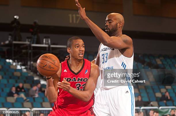 Josh Owens of the Idaho Stampede passes around defender Melvin Ely of the Texas Legends during the 2013 NBA D-League Showcase on January 7, 2013 at...