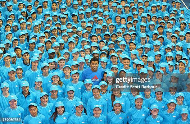 Jo-Wilfried Tsonga of France poses with the squad of 380 Australian Open 2013 ballkids at the National Tennis Centre ahead of the 2013 Australian...