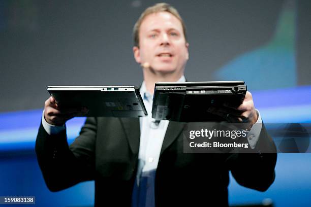 Kirk Skaugen, vice president of PC client group with Intel Corp., compares a 15-inch 4th generation Intel Core Ultrabook reference design laptop...