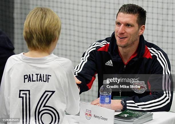 Kenny Cooper of the New York Red Bulls signs autographs during Soccer Night In Newtown at Newtown Youth Academy Sports & Fitness Center on January 7,...