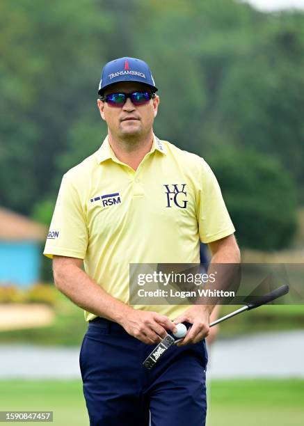 Zach Johnson of the United States walks on the on the 15th green during the first round of the Wyndham Championship at Sedgefield Country Club on...