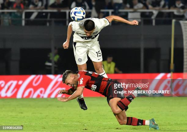 Olimpia's defender Mateo Gamarra heads the ball past Flamengo's Uruguayan midfielder Giorgian de Arrascaeta during the Copa Libertadores round of 16...