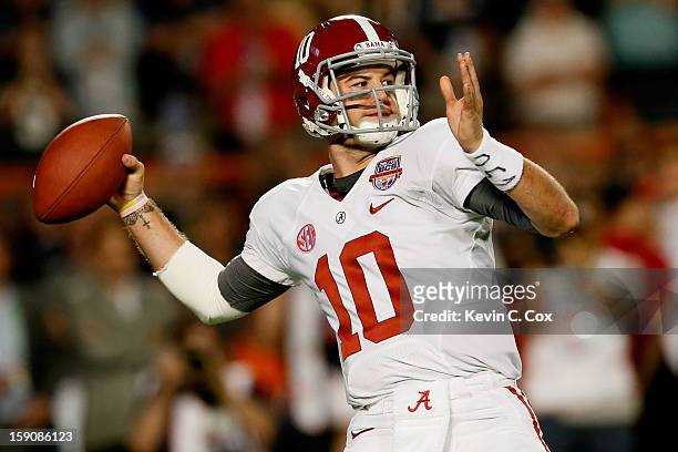 McCarron of the Alabama Crimson Tide passes against the Notre Dame Fighting Irish during the 2013 Discover BCS National Championship game at Sun Life...