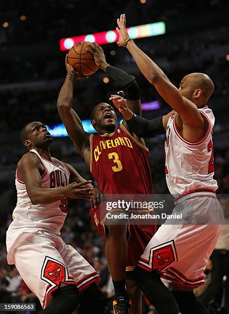 Dion Waiters of the Cleveland Cavaliers puts up a shot between Loul Deng and Taj Gibson of the Chicago Bulls at the United Center on January 7, 2013...