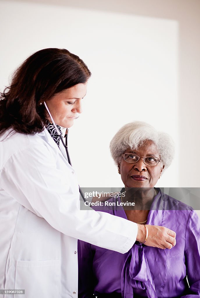 Doctor listening to a senior patient's heart