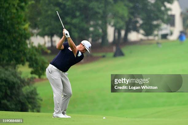 Sungjae Im of Korea plays a shot on the 14th hole during the first round of the Wyndham Championship at Sedgefield Country Club on August 03, 2023 in...