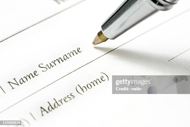 person writing surname on document - telephone directory stock pictures, royalty-free photos & images