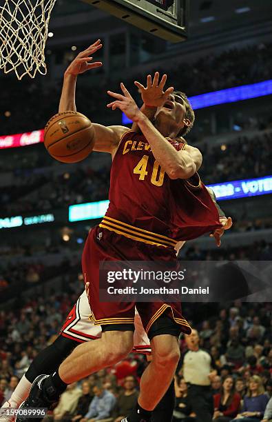 Tyler Zeller of the Cleveland Cavaliers looses the ball after being fouled by Carlos Boozer of the Chicago Bulls at the United Center on January 7,...