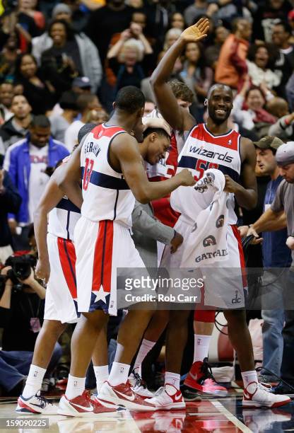 Kevin Seraphin and Emeka Okafor of the Washington Wizards celebrate during the closing seconds of the Wizards 101-99 win over the Oklahoma City...
