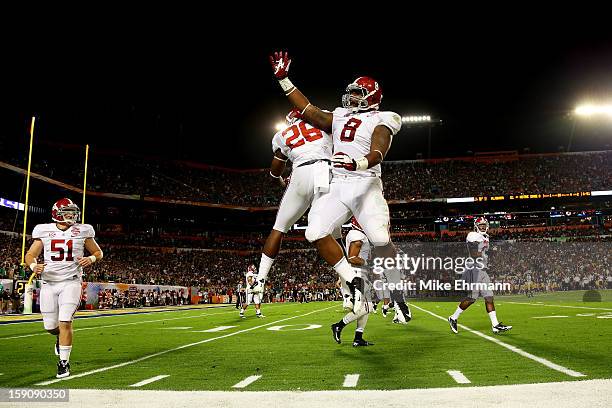 Landon Collins of the Alabama Crimson Tide and Jeoffrey Pagan celebrate after pinning the Notre Dame Fighting Irish deep in their own territory...