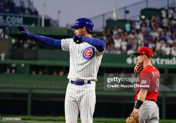 Cody Bellinger of the Chicago Cubs reacts following an RBI single during the third inning of a game against the Cincinnati Reds at Wrigley Field on...