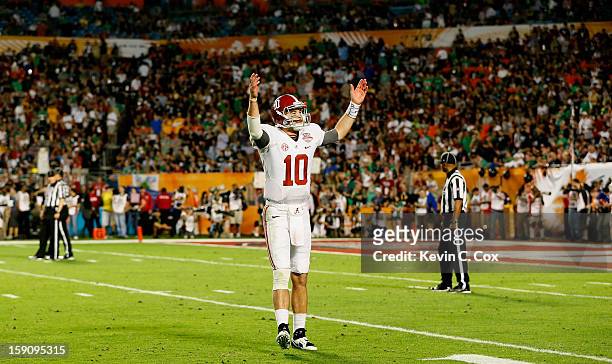 McCarron of the Alabama Crimson Tide acknowledges the crowd against the Notre Dame Fighting Irish during the 2013 Discover BCS National Championship...