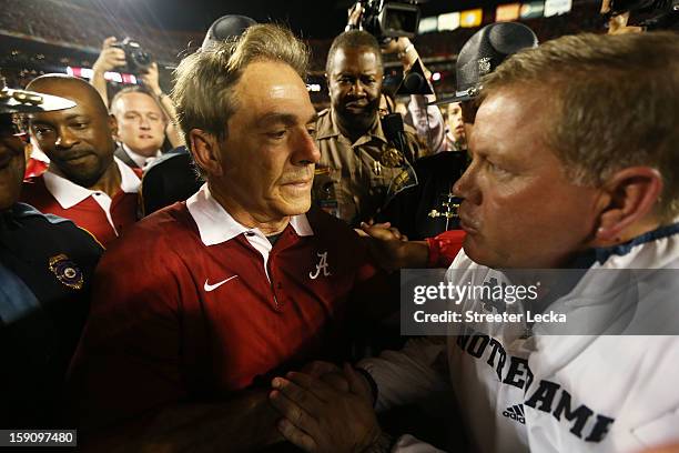 Head coach Nick Saban of the Alabama Crimson Tide and head coach Jim Kelly of the Notre Dame Fighting Irish shake hands after the 2013 Discover BCS...