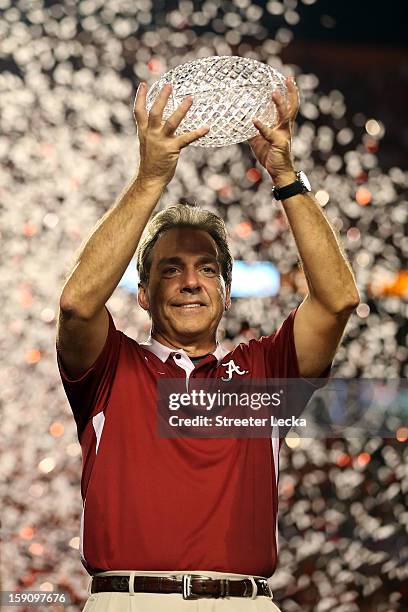 Head coach Nick Saban of the Alabama Crimson Tide celebrates with the trophy after defeating the Notre Dame Fighting Irish in the 2013 Discover BCS...