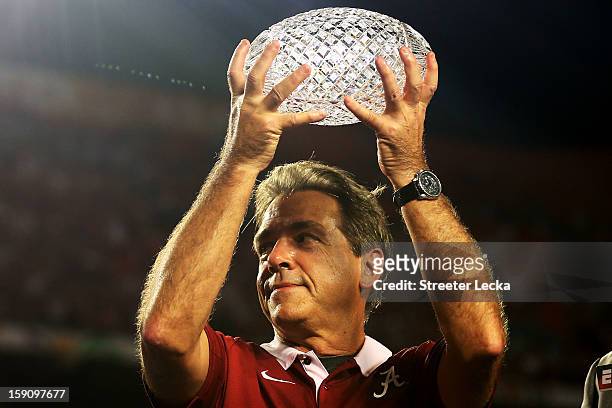 Head coach Nick Saban of the Alabama Crimson Tide celebrates with the trophy after defeating the Notre Dame Fighting Irish in the 2013 Discover BCS...