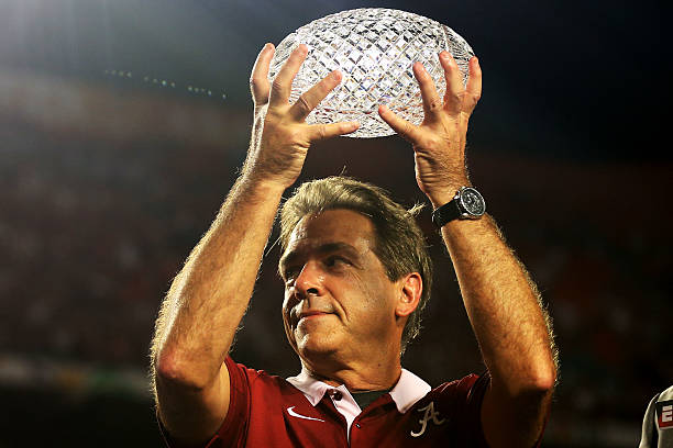 Head coach Nick Saban of the Alabama Crimson Tide celebrates with the trophy after defeating the Notre Dame Fighting Irish in the 2013 Discover BCS...