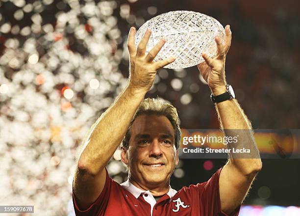 Head coach Nick Saban of the Alabama Crimson Tide celebrates with the trophy after defeating the Notre Dame Fighting Irish in the 2013 Discover BCS...