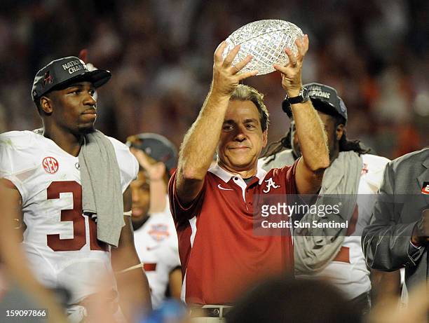 Alabama head coach Nick Saban hold the trophy aloft following a 42-14 win against Notre Dame in the BCS National Championship game at Sun Life...