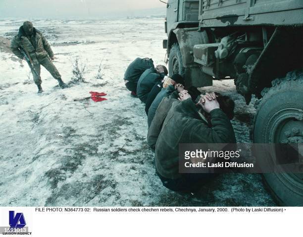 Russian soldiers check chechen rebels, Chechnya, January, 2000.