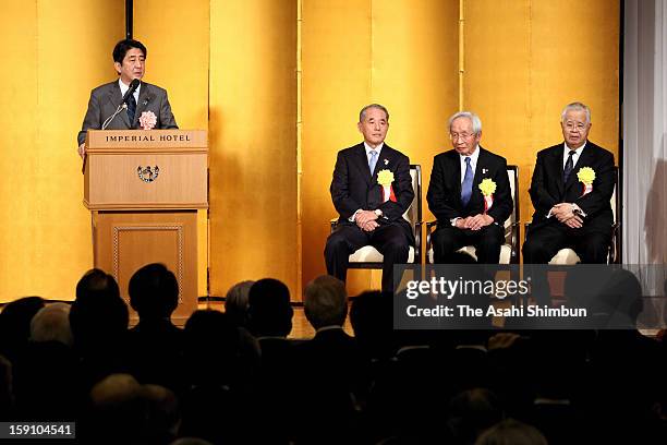 Japanese Prime Minister Shinzo Abe addresses while Japan Association of Corporate Executives chairman Yasuchika Hasegawa , Japan Chamber of Commerce...