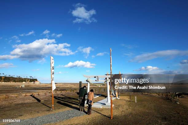 People pray at a small shrine on Janaury 1, 2013 in Minamisoma, Fukushima, Japan. Japan mark the second new year after the earthquake and tsunami.