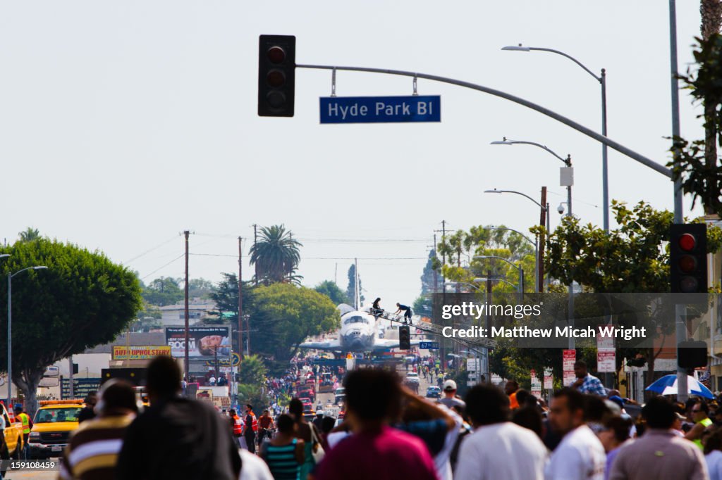 The Space Shuttle moves through Los Angeles