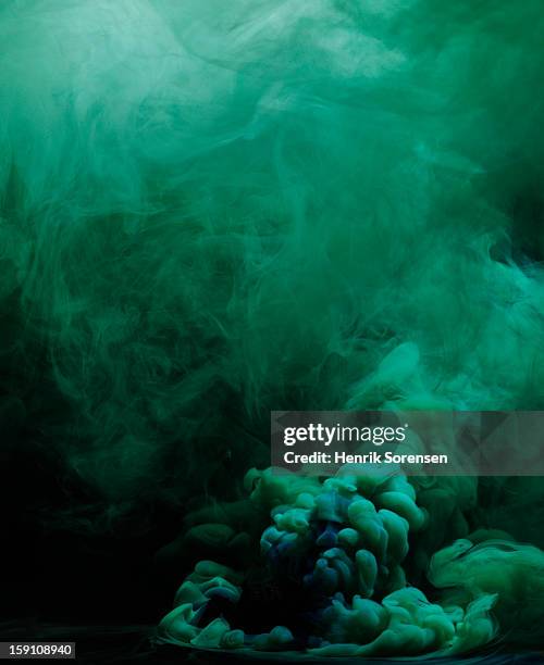 green smoke - colored smoke stock pictures, royalty-free photos & images