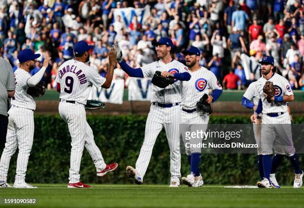 Nick Madrigal, Jeimer Candelario, Cody Bellinger, Mike Tauchman and Dansby Swanson of the Chicago Cubs celebrate after the win over the Cincinnati...