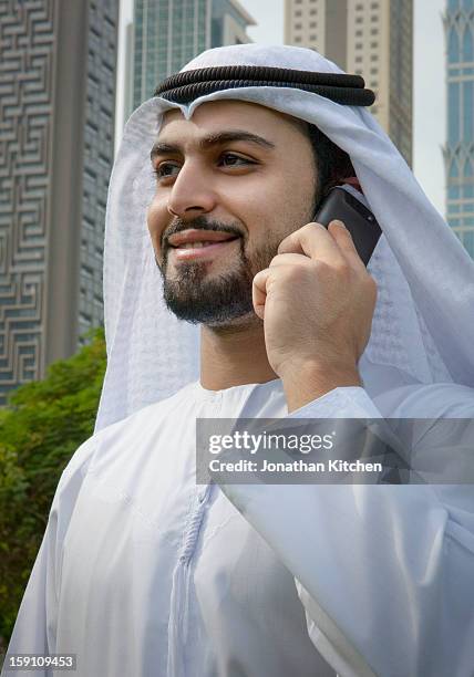 middle eastern business with smartphone - ghoutra stock pictures, royalty-free photos & images