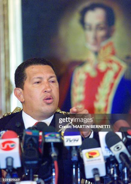 Venezuelan President Hugo Chavez speaks at a press conference in Caracas 15 April 2002 after returning to power early 14 April following a...