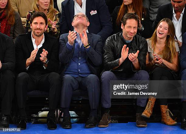 Henrik Lundqvist, guest, David Duchovny and Madelaine Duchovny attend the Boston Celtics vs New York Knicks game at Madison Square Garden on January...