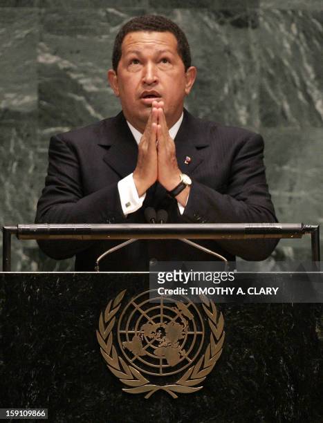 Venezuelan President Hugo Chavez makes a gesture of prayer as he speaks of US President George W. Bush whom he refered to as "the Devil" during his...