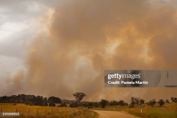 Smoke rises as fires rage in the Kybeyan Valley, New South Wales on January 8, 2013 in Nimmitabel, Australia. NSW was declared a total fire ban with...