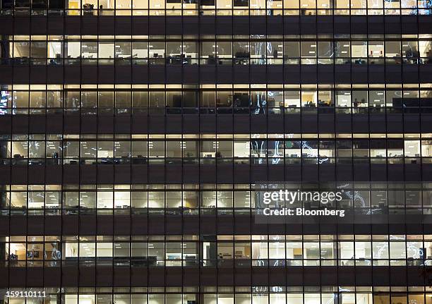 Offices in a building are illuminated at night in the central business district of Hong Kong, China, on Friday, Jan. 4, 2013. Hong Kong topped the...