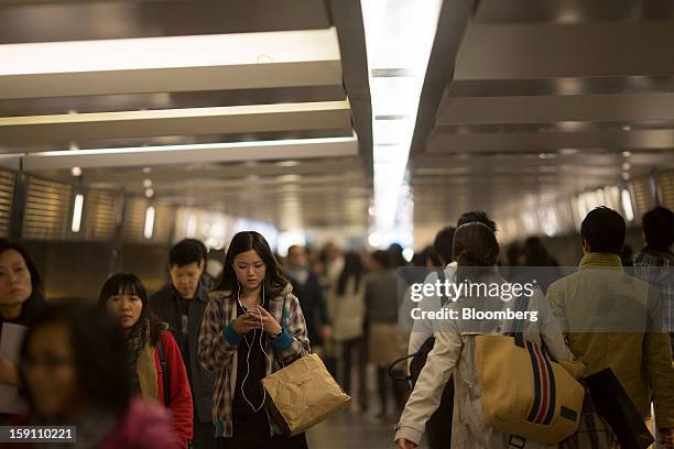 Pedestrians walk on an overpass in the central business district of Hong Kong, China, on Friday, Jan. 4, 2013. Chief Executive Leung Chun-ying, who...