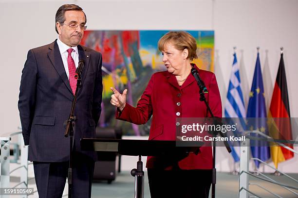 German Chancellor Angela Merkel and Greek Prime Minister Antonis Samaras give statements to the media following a meeting between the two leaders at...