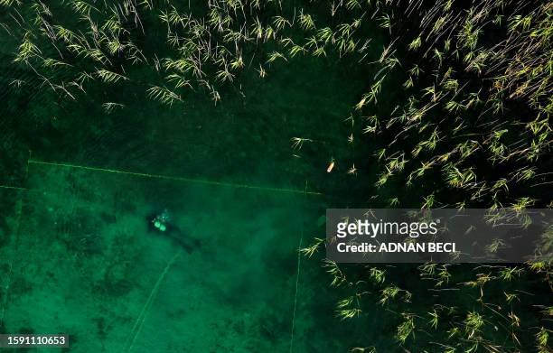 This photograph taken on July 27 shows a diver searching for archaeological material in Lake Ohrid, southeastern Albania. A mixed team of Albanian...