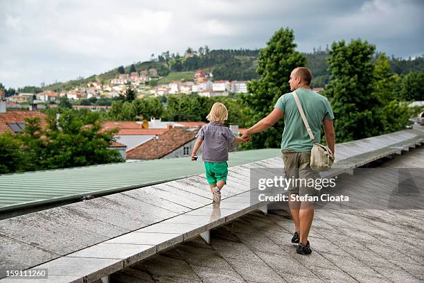 father & son admiring city panorama - santiago de compostela stock-fotos und bilder