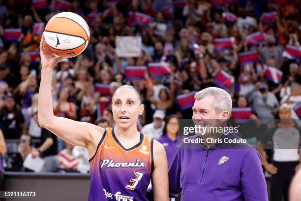 Guard Diana Taurasi of the Phoenix Mercury reacts with former Phoenix Mercury general manager Jim Pitman after scoring her 10,000th career point...