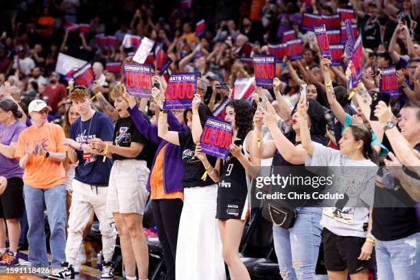 Fans react after guard Diana Taurasi of the Phoenix Mercury scored her 10,000th career point during the game against the Atlanta Dream at Footprint...