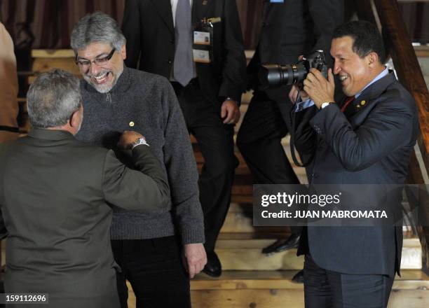 Venezuelan President Hugo Chavez takes pictures of Brazilian President Luiz Inacio Lula da Silva as he talks with his Paraguayan counterpart Fernando...