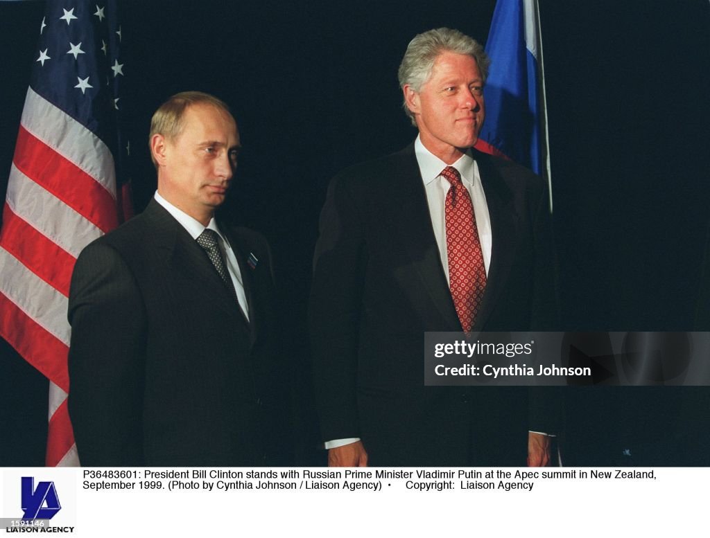 President Bill Clinton stands with Russian Prime Minister Vladimir Putin...