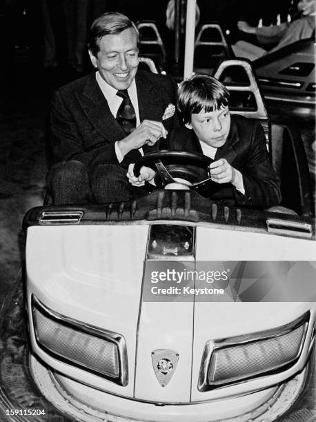 Prince Claus, the husband of Queen Beatrix of the Netherlands and his son Prince Constantijn try out a dodgem car in the town of Breda, Netherlands,...