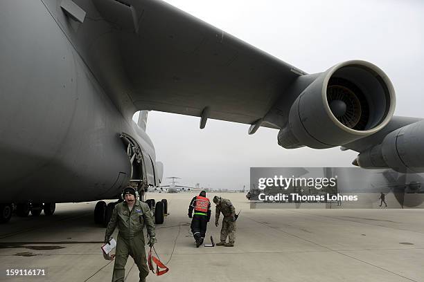 Soldiers of the U.S. Army Europe's 10th Army Air and Missile Defense Command, who operate Patriot anti-missile systems, load cargo on board a plane...