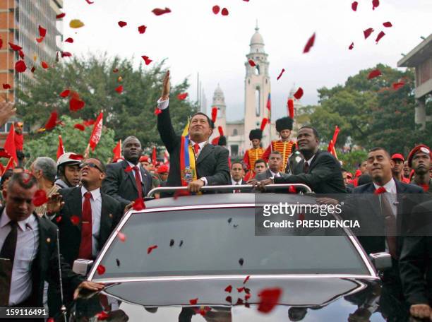 Venezuela's President Hugo Chavez greets supporters as he rides in an open car to Congress in Caracas, 10 Janary 2007. Chavez, a harsh critic of the...