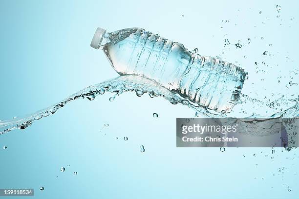 big splash with water bottle - bottled water stock pictures, royalty-free photos & images