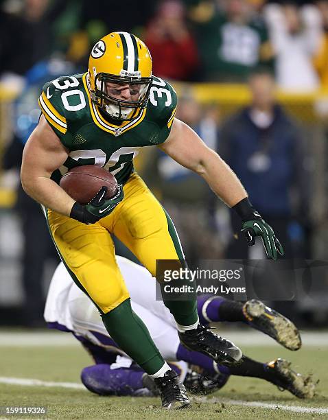 Fullback John Kuhn of the Green Bay Packers scores on a nine-yard touchdown catch and run in the third quarter against the Minnesota Vikings during...