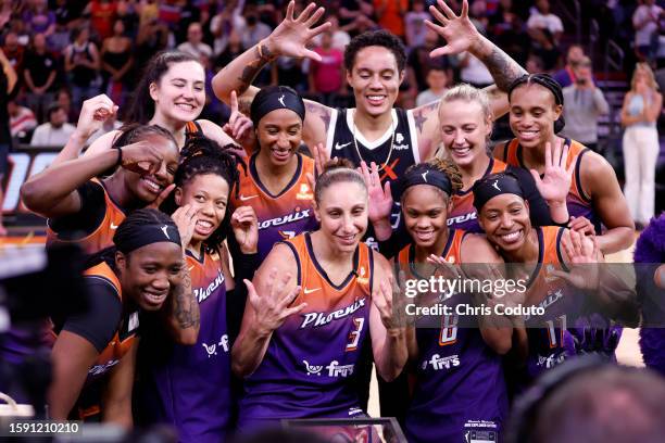 Guard Diana Taurasi of the Phoenix Mercury poses for a photo with teammates while being honored after scoring 10,000 career points at Footprint...