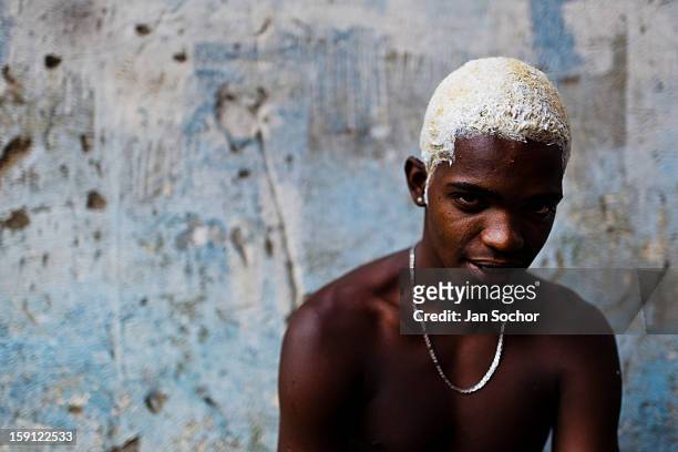 Member of Império Serrano samba school bleaches his hair with peroxide inside the workshop in Rio de Janeiro, Brazil, 15 February 2012. The carnival...