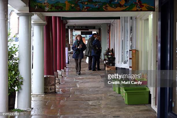 People browse in shops along the main shopping street of Totnes on January 8, 2013 in Totnes, England. The Devon town is renowned for its belief in...